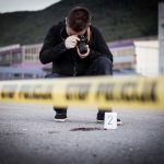 Photographer At Crime Scene