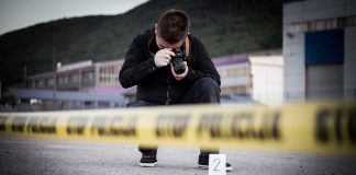 Photographer At Crime Scene