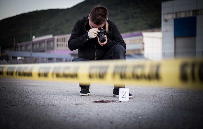 Photographer At Crime Scene