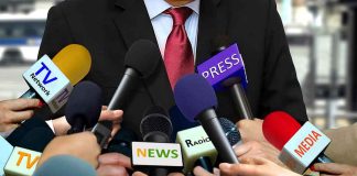 Man in a Suit Being Interviewed for Media