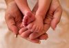 Image of hands holding a baby's feet