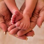 Image of hands holding a baby's feet