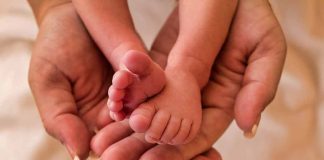 Image of hands holding a baby's feet