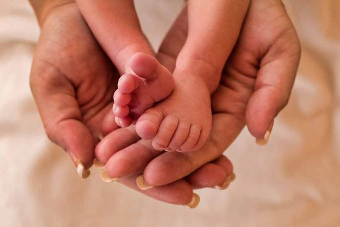 Image of hands holding a baby's feet