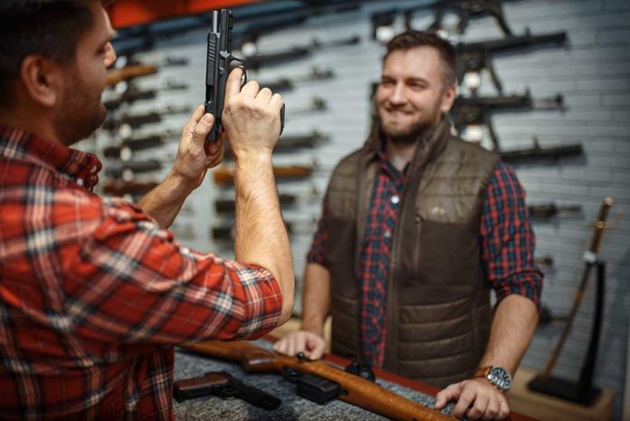 Man Showing Gun To Another Man