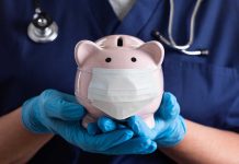 Nurse Holding A Piggy Bank