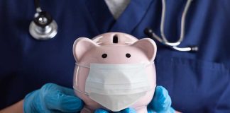 Nurse Holding A Piggy Bank