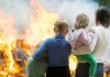 People standing in front of flames