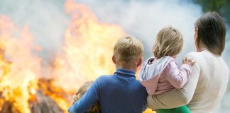 People standing in front of flames