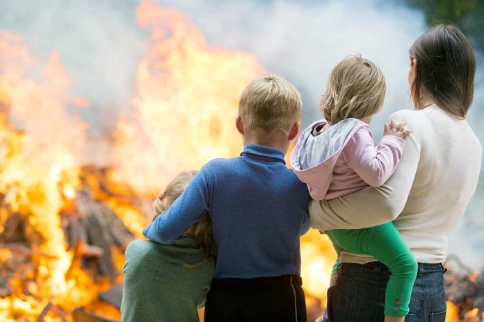 People standing in front of flames