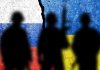 Soldiers against the Russian and Ukrainian flags