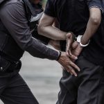 Man in handcuffs and a police officer