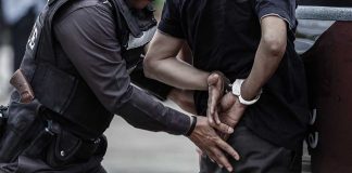 Man in handcuffs and a police officer