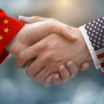 Chinese and American flag sleeves shaking hands