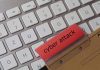 Keyboard with red folder labeled cyber attack