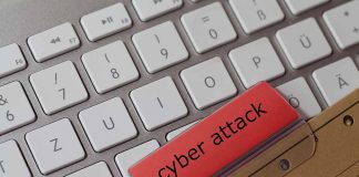 Keyboard with red folder labeled cyber attack