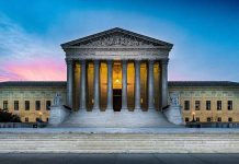 Supreme Court building with illuminated pillars and steps