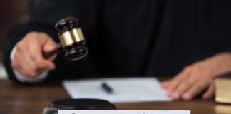 Judge with gavel and Supreme Court nameplate
