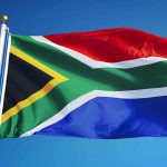 South African flag waving against blue sky