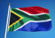 South African flag waving against blue sky