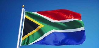 South African flag waving against blue sky