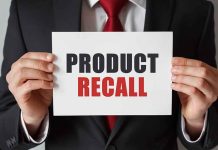 Product Recall sign held by person in suit