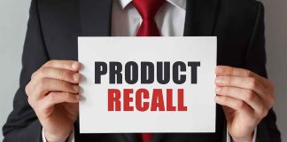 Product Recall sign held by person in suit