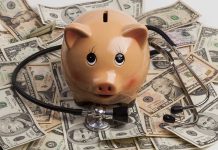 Piggy bank stethoscope money scattered underneath currency bills
