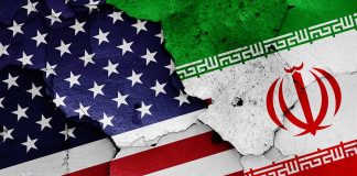 Cracked American and Iranian flags on a wall