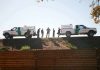 Border Patrol vehicles and agents on a ridge