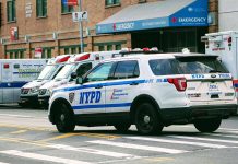 Police car and ambulances outside emergency room entrance