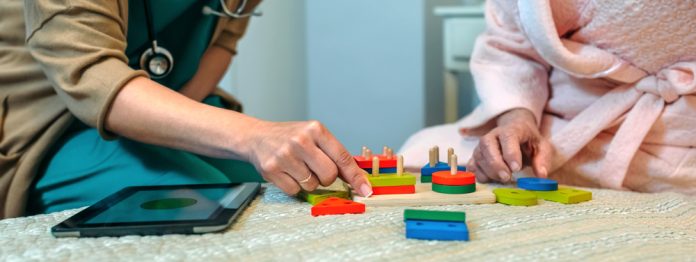 1506636815 featured image Doctor and patient playing with colorful wooden blocks