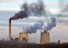 Industrial plant emitting black smoke into the sky