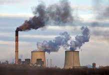 Industrial plant emitting black smoke into the sky