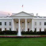 The White House with fountain and American flag
