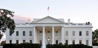 The White House with fountain and American flag