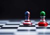 Chess pieces with USA and Iran flags on board