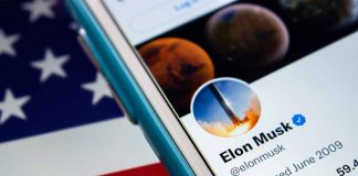 Smartphone showing a Twitter profile, American flag background