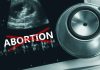 Ultrasound stethoscope and ABORTION crossed out in red