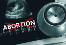Ultrasound stethoscope and ABORTION crossed out in red