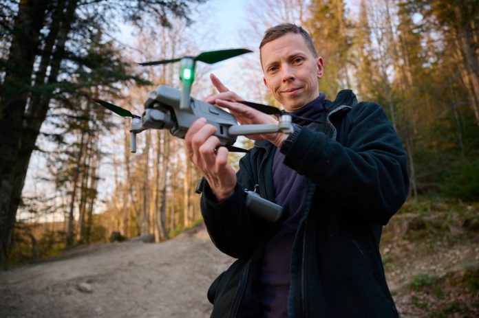 2479750341 featured image Person holding a drone in a forest