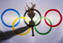 Olympic rings with a torch shadow