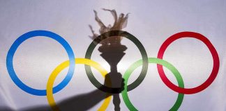 Olympic rings with a torch shadow