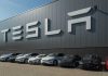 Tesla facility with parked cars in front