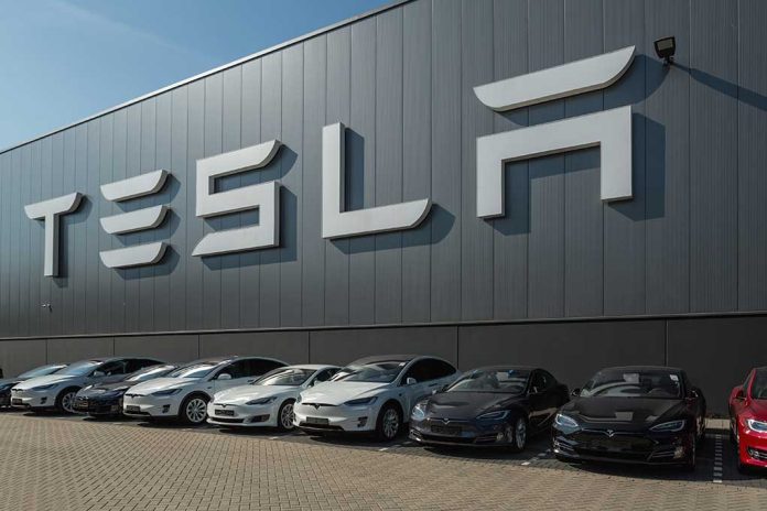 489388897 featured image Tesla facility with parked cars in front