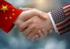 Chinese and American flag sleeves shaking hands