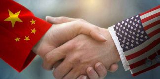 Chinese and American flag sleeves shaking hands