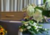 White roses in front of a casket