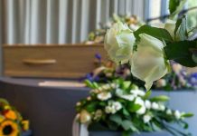 White roses in front of a casket