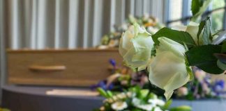 White roses in front of a casket